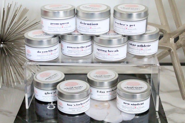 School Scents travel tins displayed on stacked acrylic riser